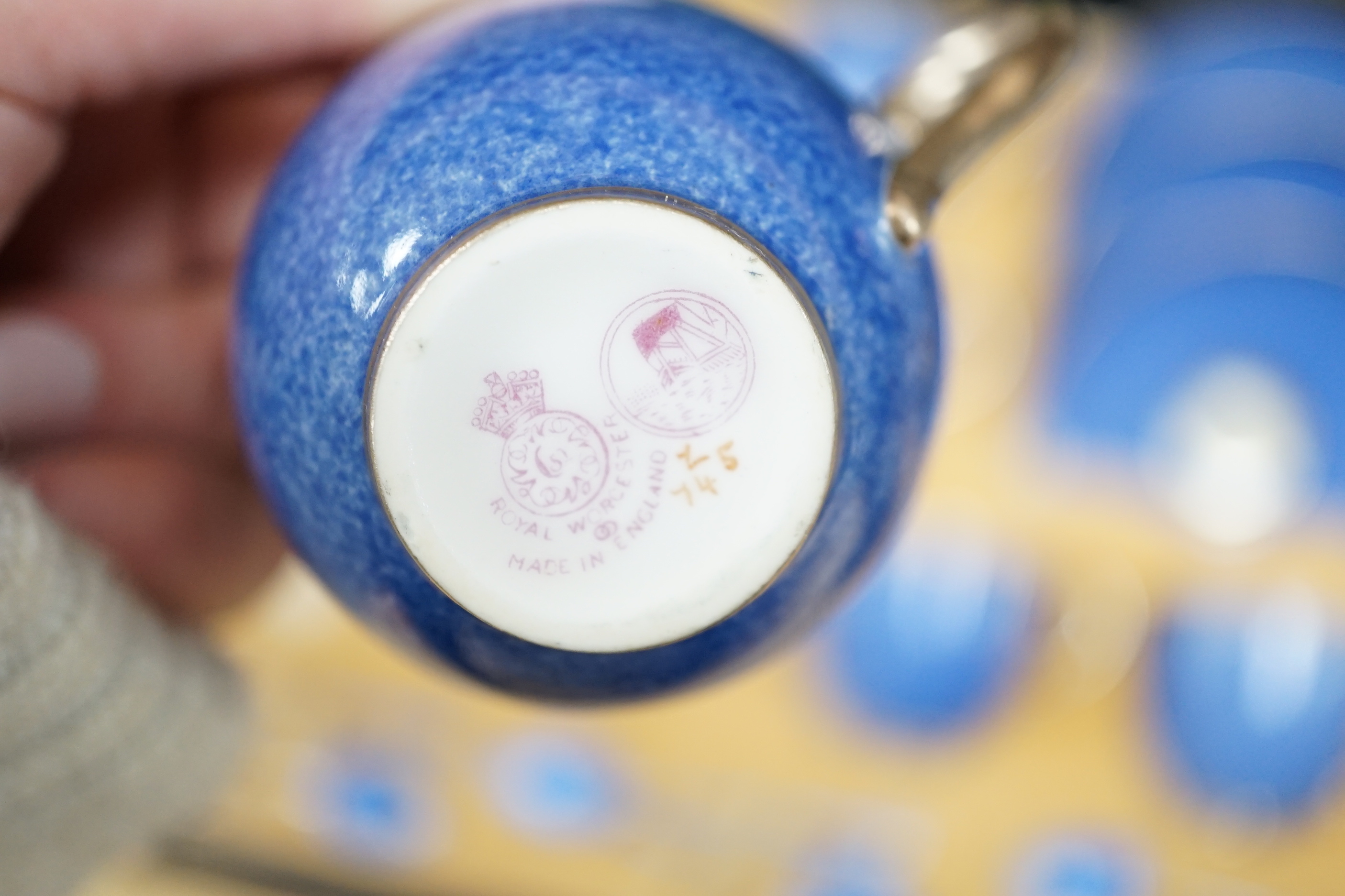 A cased Worcester powder blue and silvered coffee set with enamelled silver spoons together with a cased set of six green and frosted glass salts